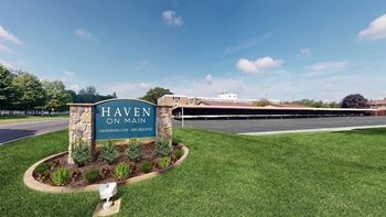 a sign for heaven on main in front of a parking lot